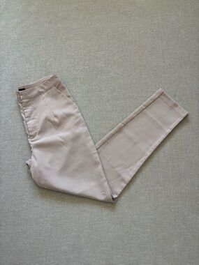 WOMAN pale pink satin trousers.